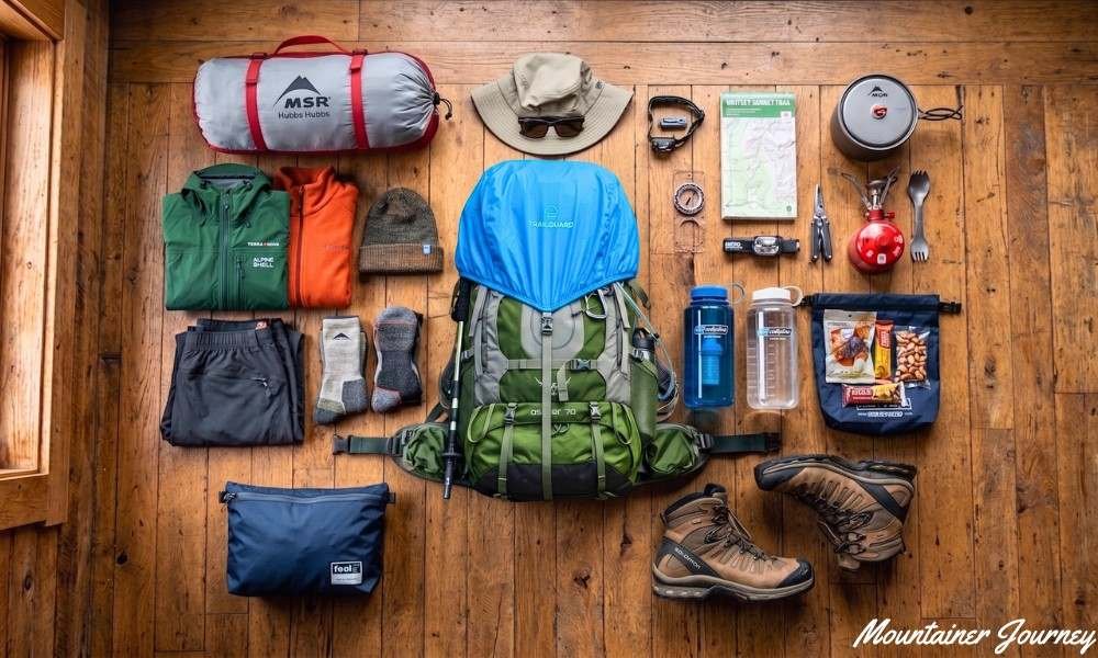 Backpacking gear arranged before choosing the final backpack size
