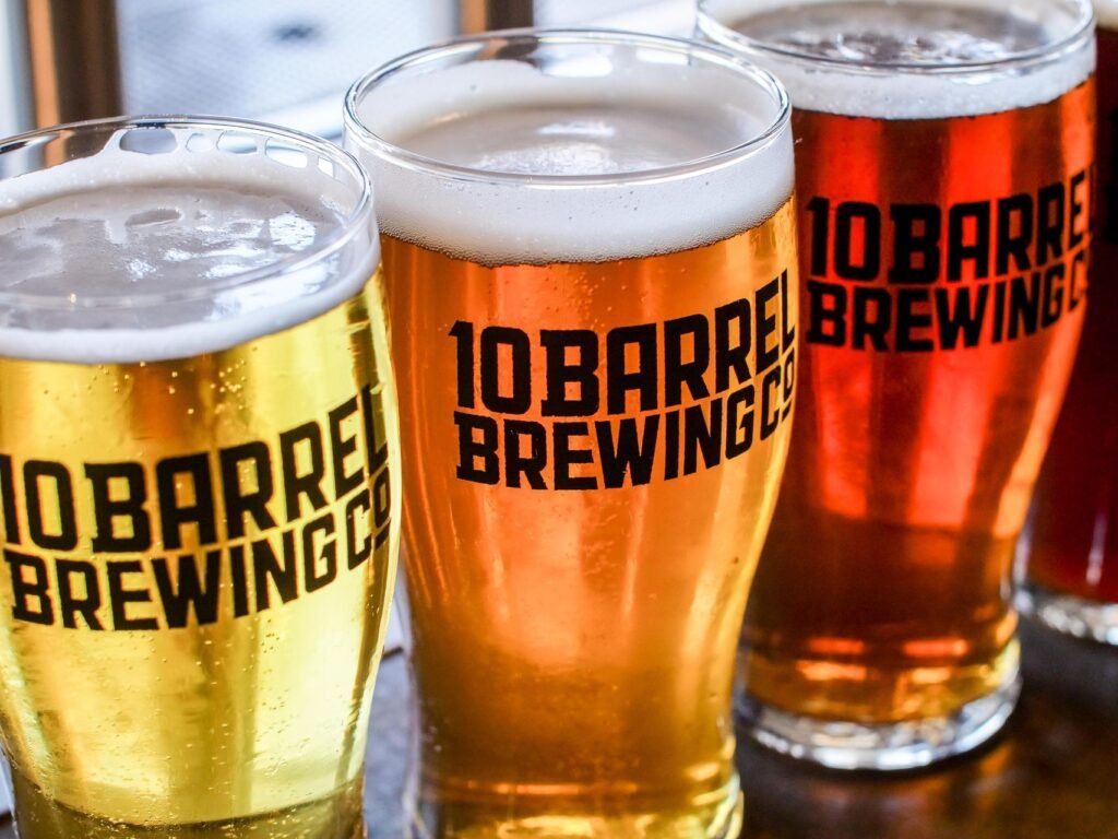 Three glasses of craft beer in varying shades on a table