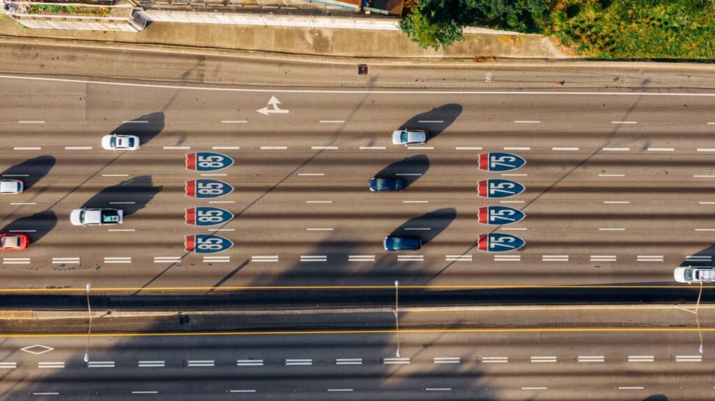 Overhead view of cars on Atlanta's I-85 and I-75 highways on a sunny day