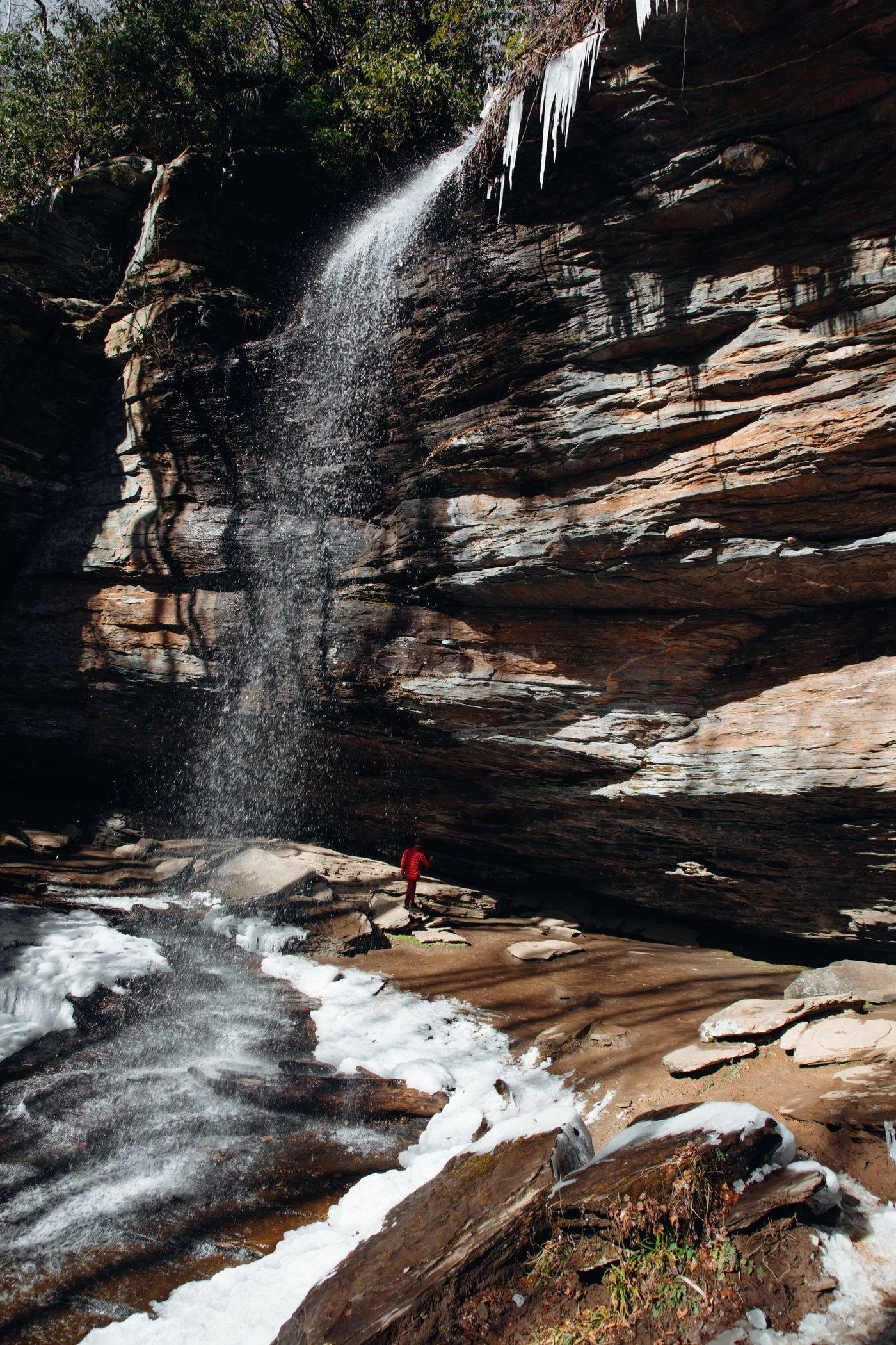 A waterfall in the mountains near Brevard, North Carolina, surrounded by rocks and lush foliage
